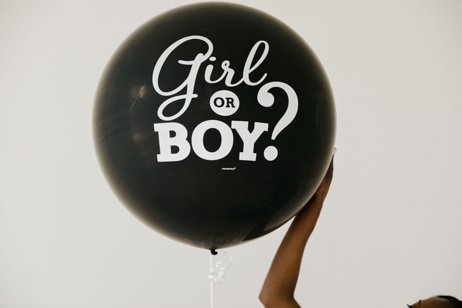 Black balloon reading Girl or Boy