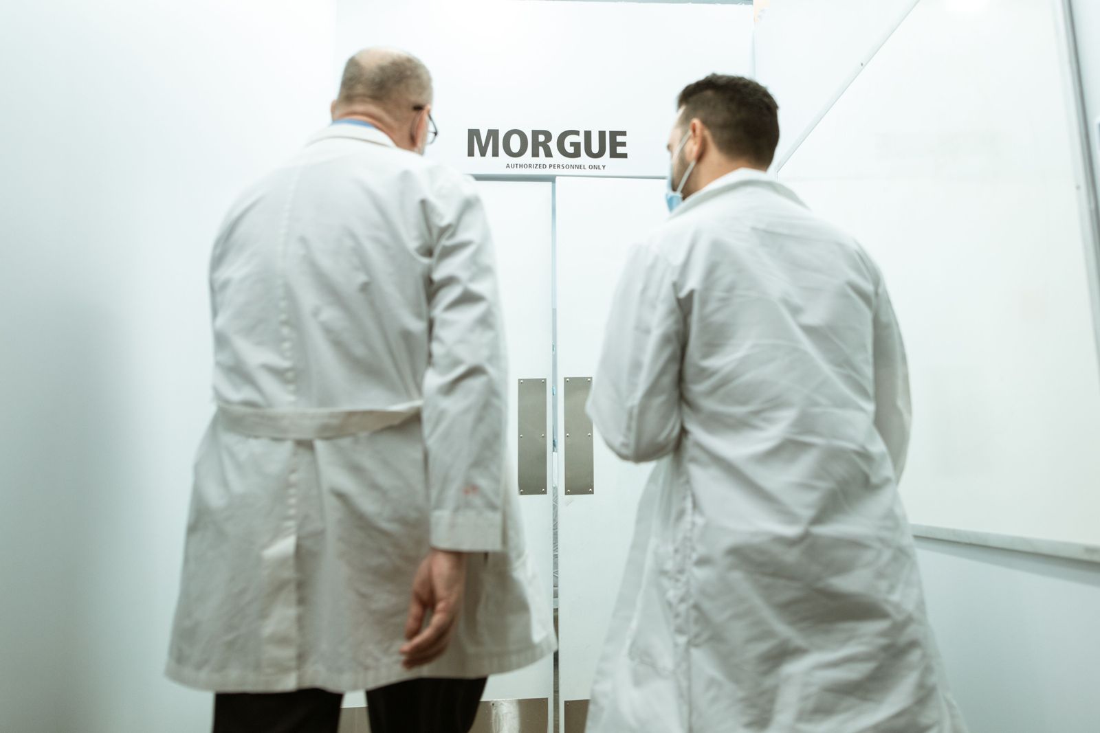 Two medical examiners in lab coats