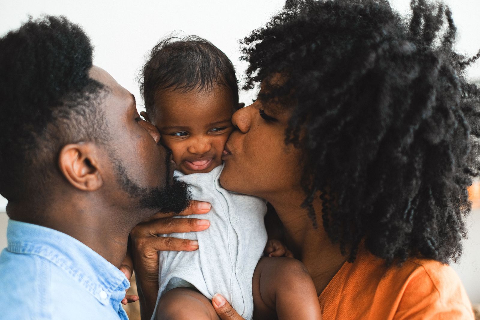 Parents kissing their toddler